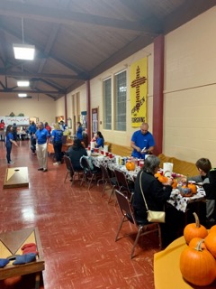 Tables with people gathered around them.