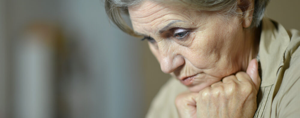 aging woman resting head on fists