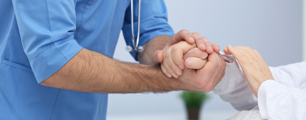 doctor holding patient hand